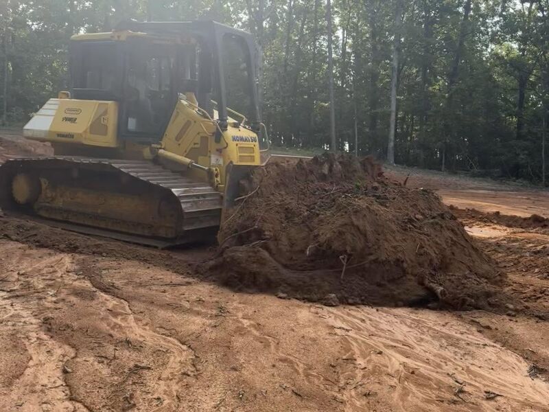 Dozer pushing dirt and clearing land for Roach Farms & Construction